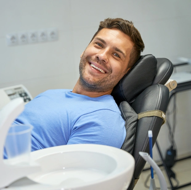 Man smiling in dental chair at Bethany Heights Dental Care office during examination.